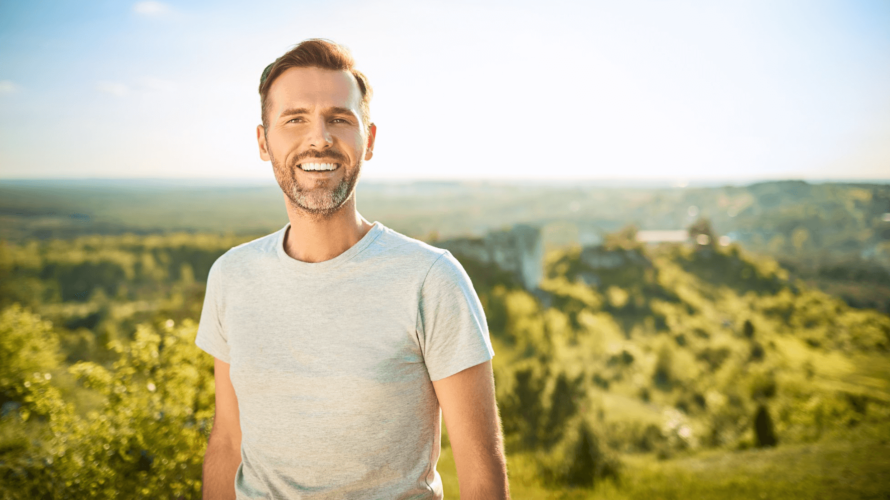 older man smiling outside